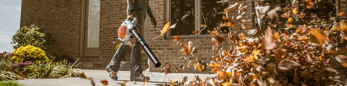 Person blowing leaves with Stihl leaf blower